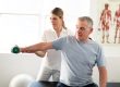 A Modern rehabilitation physiotherapy worker with senior client