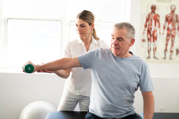A Modern rehabilitation physiotherapy worker with senior client A Modern rehabilitation physiotherapy worker with senior client
