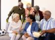 Cheerful multiracial senior friends talking while enjoying beer