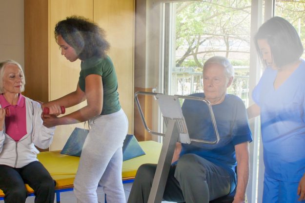 Rehabilitation concept. Elderly retired couple training in a gym Rehabilitation concept. Elderly retired couple training in a gym