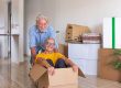 Happy senior couple white haired having fun during relocation