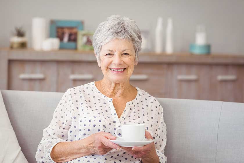 Portrait of senior woman holding coffee cup Portrait of senior woman holding coffee cup