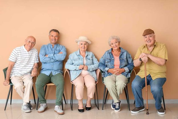 Senior people sitting on chairs in room Senior people sitting on chairs in room