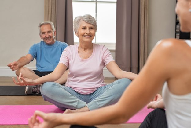 Old couple sitting in lotus position 3 Reasons You Should Start Meditating In Your Boca Raton, FL Retirement Community