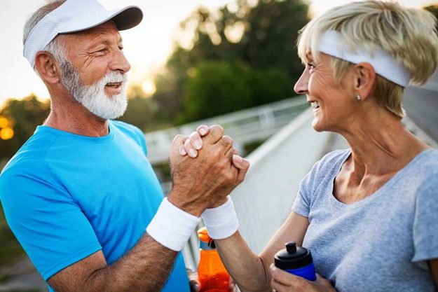 senior-couple-staying-fit-by-exercise-jogging Happy senior couple staying fit by exercise jogging