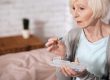 Side view of senior woman taking pill