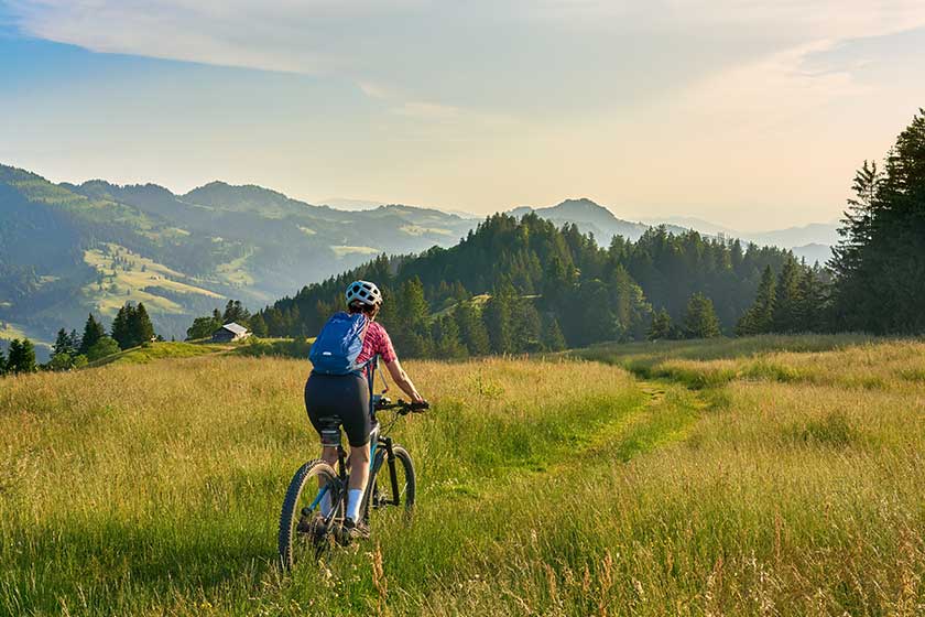 Pretty senior woman riding her electric mountain bike