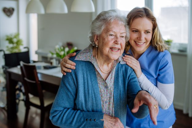 Young nurse hugging her senior woman client. How Assisted Living Facilities In Palm Beach County, FL Empower Your Loved Ones With Walking Assistance Service