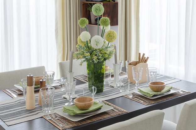 Table set on wooden dinning table with flower Table set on wooden dinning table with flower