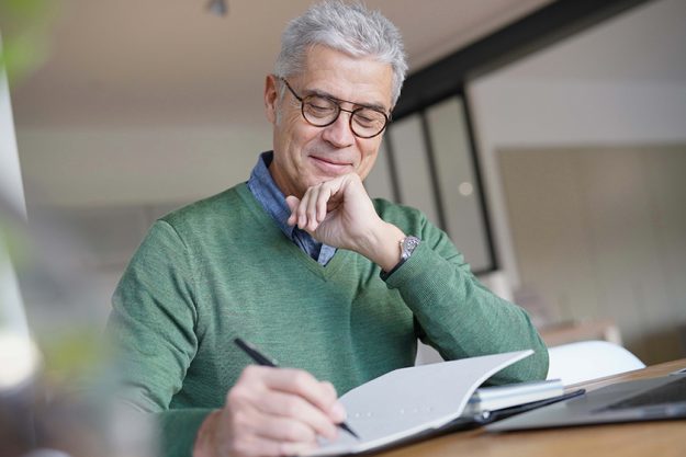 Modern senior man working on laptop at home Modern senior man working on laptop at home