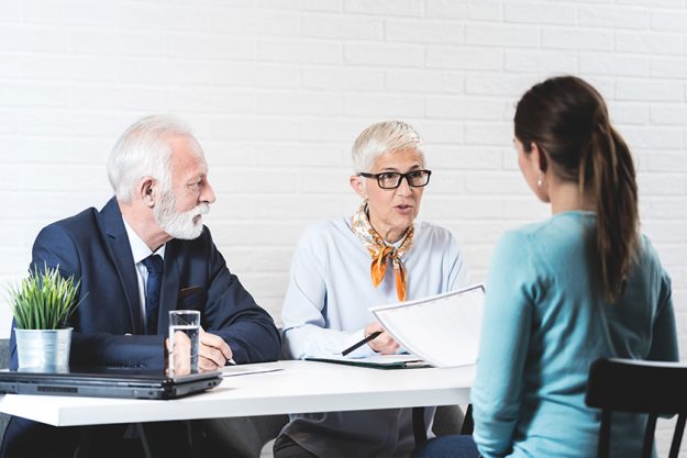Young girl in a meeting with a senior couple Young girl in a meeting with a senior couple