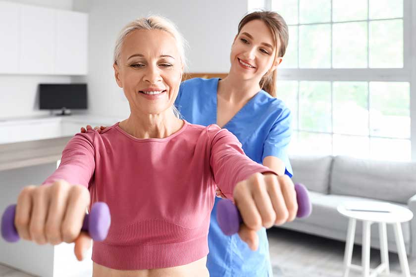 Mature woman training with dumbbells and female Mature woman training with dumbbells and female