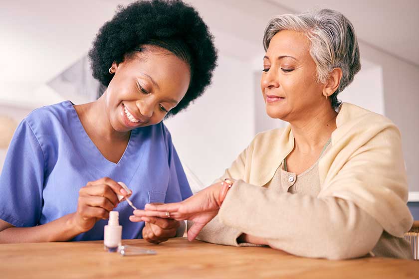 Nursing home, manicure and a caregiver with a senior Nursing home, manicure and a caregiver with a senior