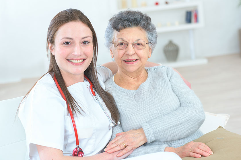 Doctor sat with a senior patient