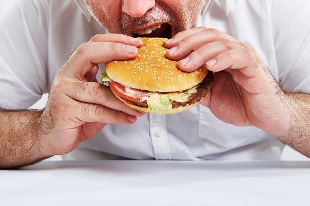 man eating burger man eating burger