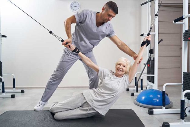 Aging female laying down while holding two cables Aging female laying down while holding two cables