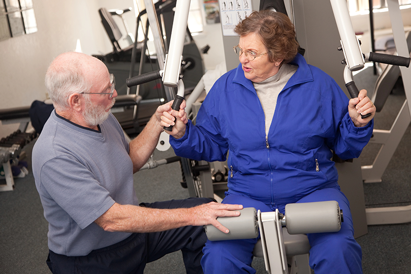 senior couple working out in the gym