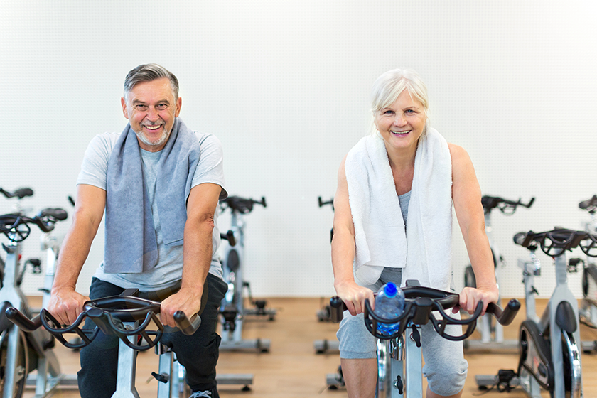 senior couple exercising in gym