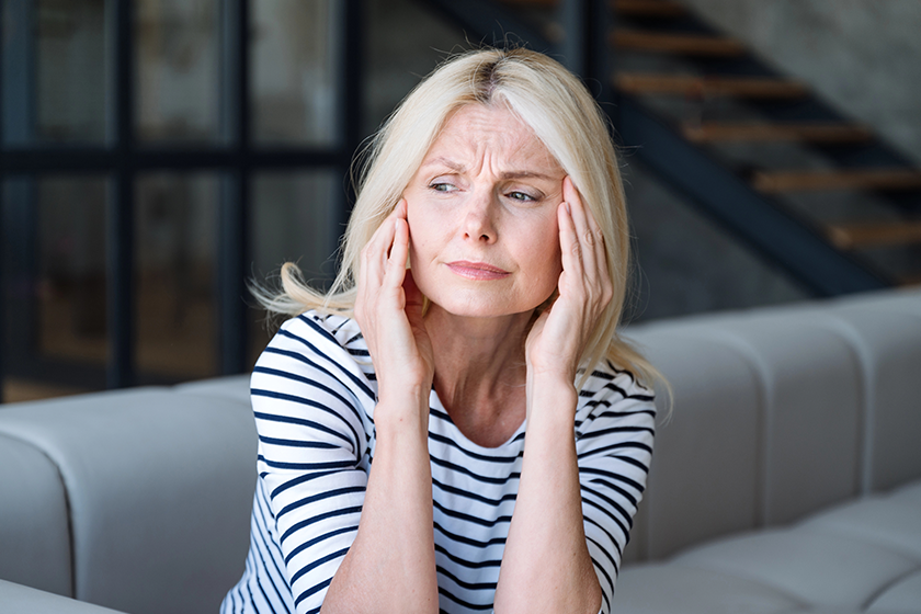 frustrated middle aged woman sitting couch