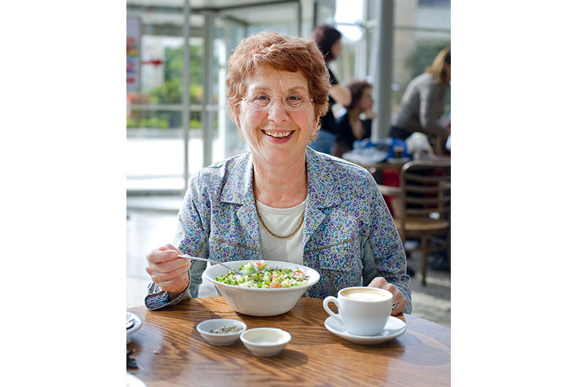 Senior women having salad and coffee