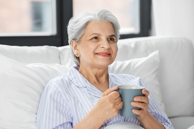 old woman with cup of coffee in bed old woman with cup of coffee in bed