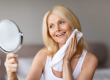 happy middle aged woman looking herself