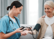 nurse doctor old woman blood pressure test
