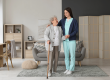 young caregiver helping senior woman