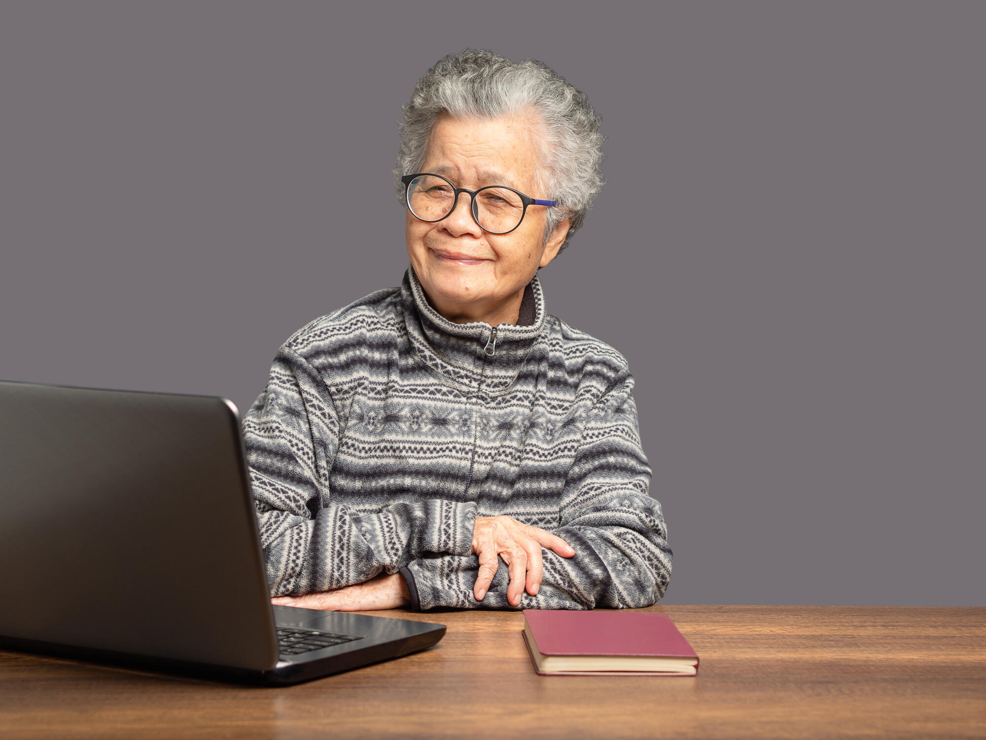 An elderly Asian woman with short gray hair looks at the camera An elderly Asian woman with short gray hair looks at the camera