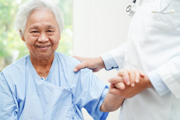 Doctor holding hands Asian elderly woman patient, help and care Doctor holding hands Asian elderly woman patient, help and care