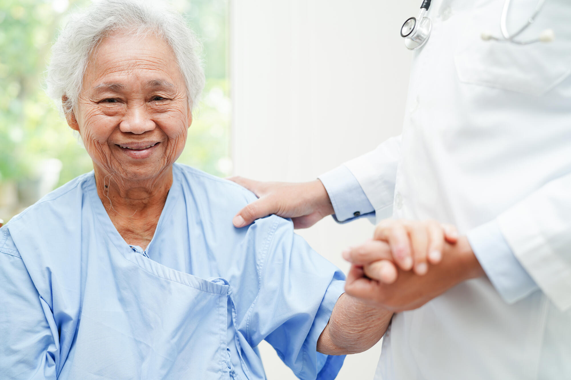 Doctor holding hands Asian elderly woman patient, help and care Doctor holding hands Asian elderly woman patient, help and care